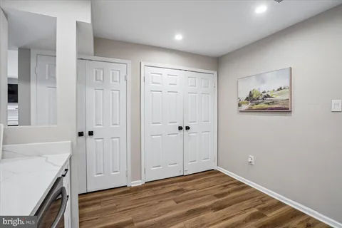 a bedroom with a bed a large window and a desk