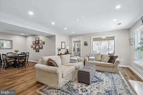 a kitchen with white cabinets appliances and wooden floor