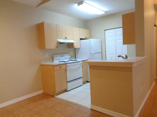 a view of a kitchen with appliances and cabinets