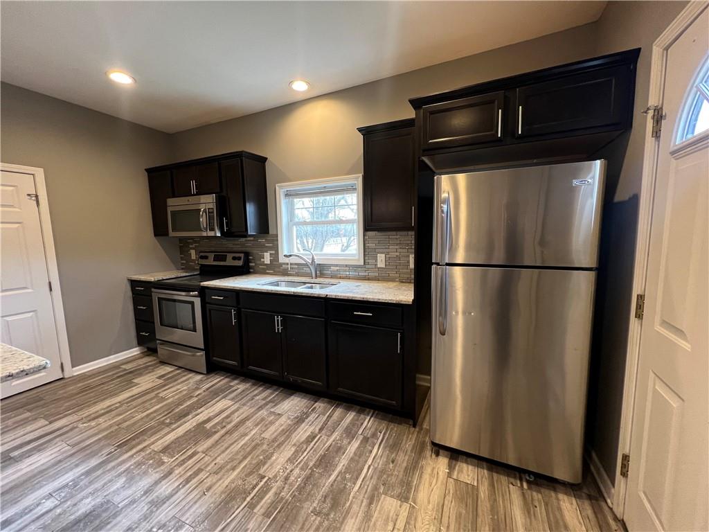 1105 Riverside Drive, Unit 1 Beaver, PA 15009 - Photo 7 of 20 a kitchen with stainless steel appliances granite countertop a refrigerator a sink and a stove top oven