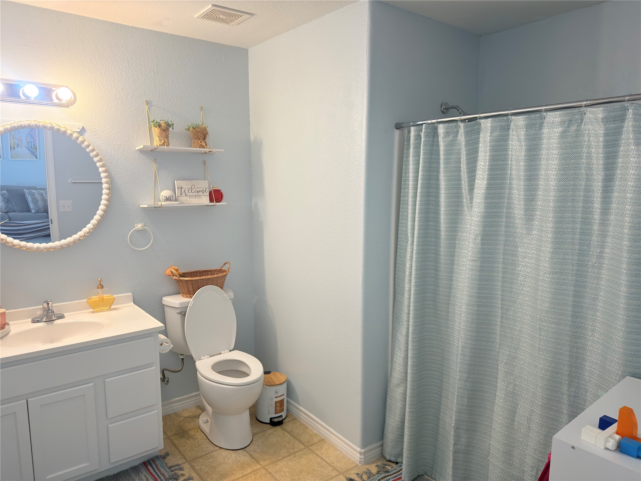 1900 Thomas Boulevard Port Arthur, TX 77640 - Photo 5 of 9 a bathroom with a toilet a sink and a mirror