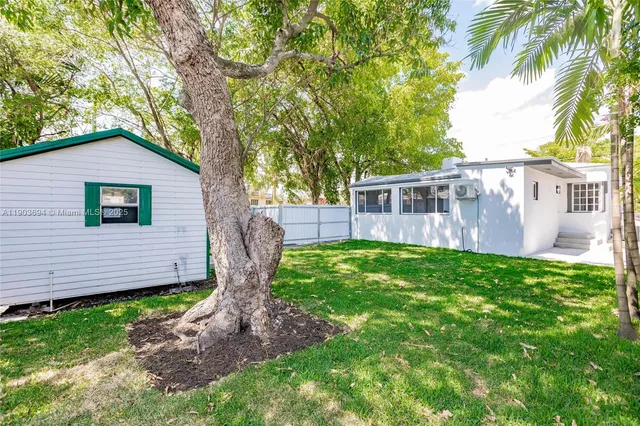 a view of backyard with small cabin