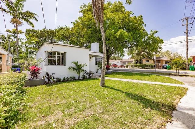 a view of swimming pool with a garden and trees