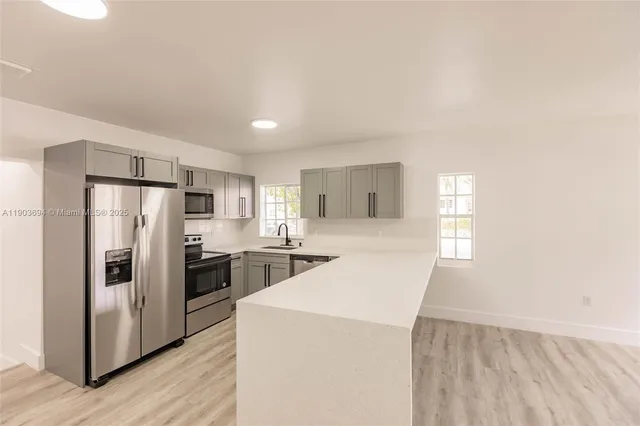 a kitchen with sink and window