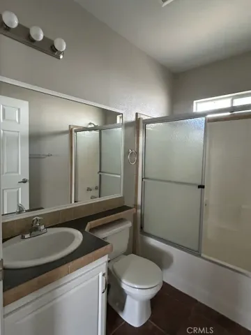 a bathroom with a sink toilet a mirror and shower