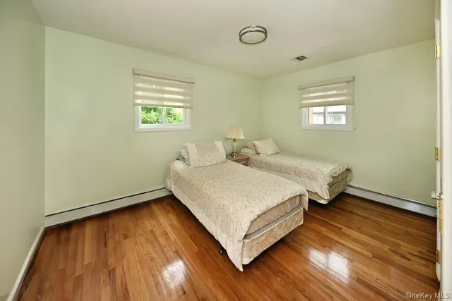 a bathroom with a sink toilet vanity and shower