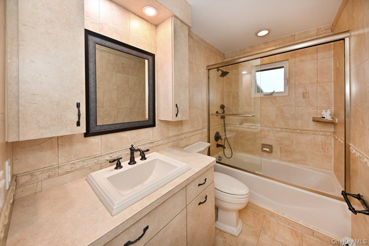 2 Elener Lane Spring Valley, NY 10977 - Photo 12 of 30 a bathroom with a sink toilet vanity and shower
