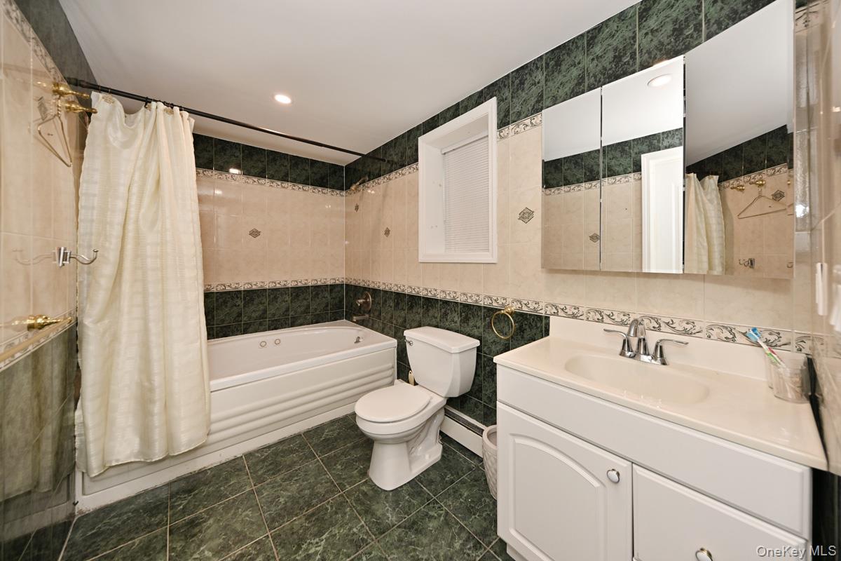 2 Elener Lane Spring Valley, NY 10977 - Photo 14 of 30 a bathroom with a sink toilet and shower