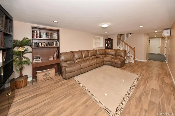 a living room with a couch and a bookshelf