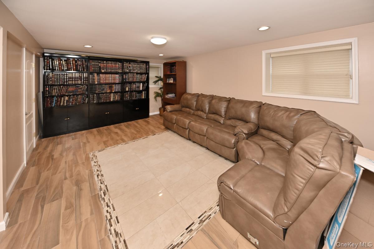 2 Elener Lane Spring Valley, NY 10977 - Photo 17 of 30 a living room with a couch and a bookshelf