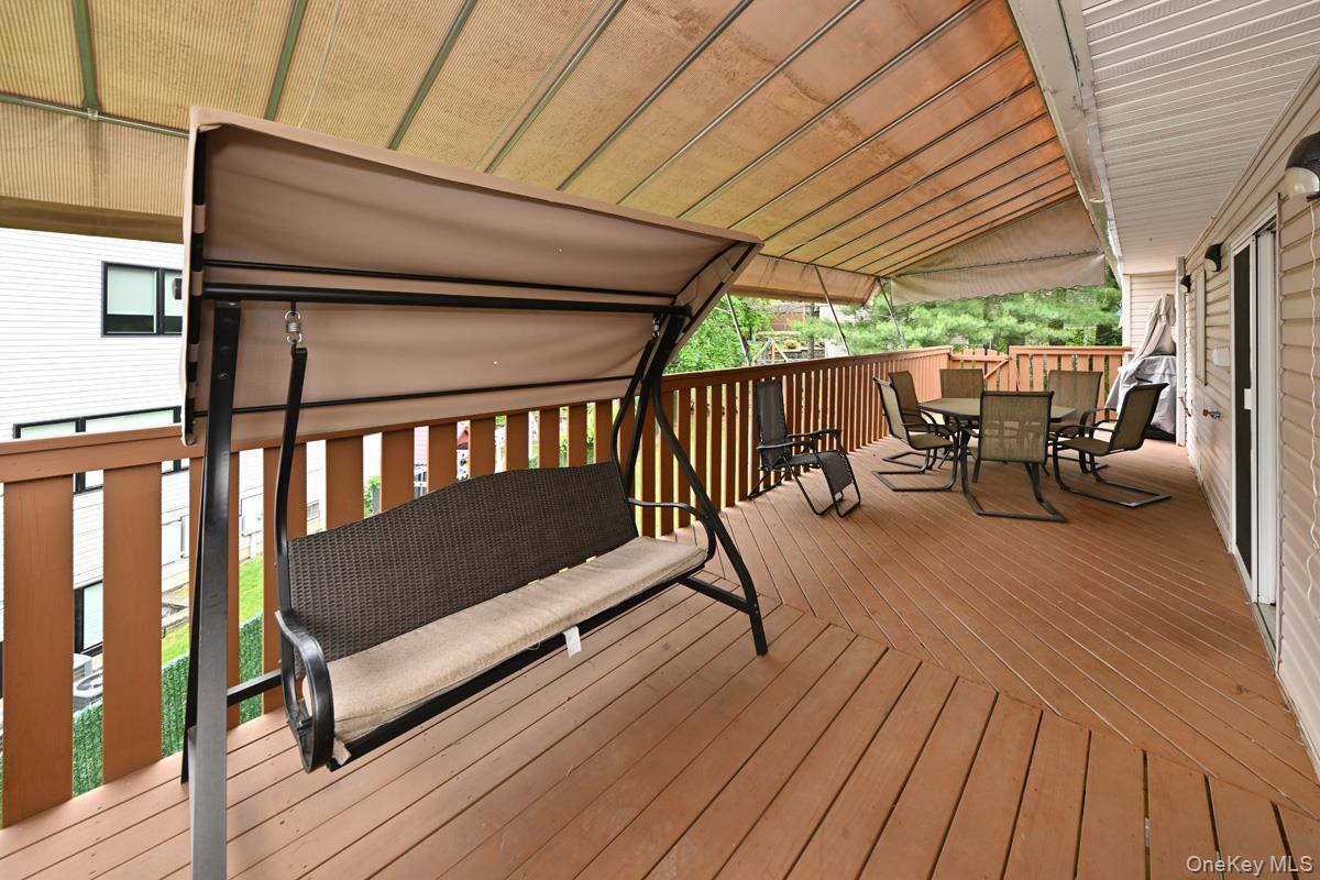 2 Elener Lane Spring Valley, NY 10977 - Photo 27 of 30 a balcony with wooden floor outdoor seating and yard in the back