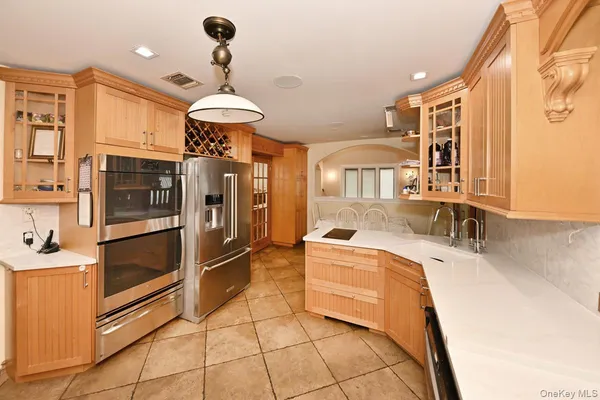 a dining room with furniture and a floor to ceiling window