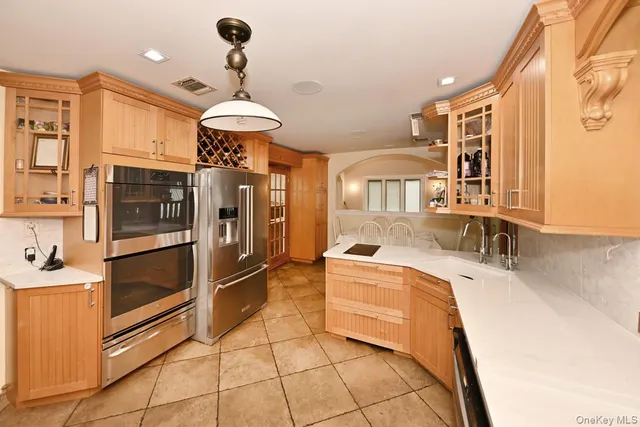 a dining room with furniture and a floor to ceiling window