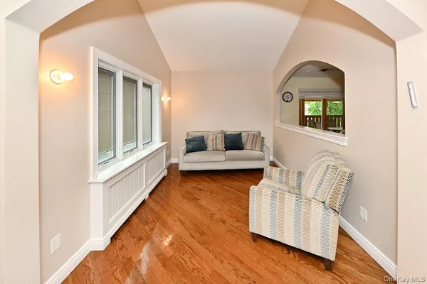 a bedroom with two beds and a wooden floor