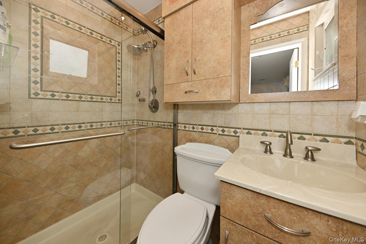 2 Elener Lane Spring Valley, NY 10977 - Photo 10 of 30 a bathroom with a sink a toilet and shower