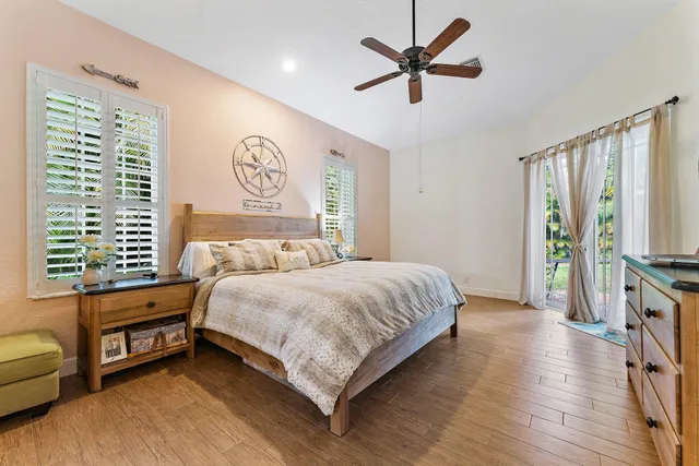 a bedroom with a bed dresser and a window