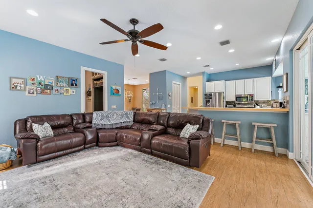a living room with a couch and kitchen view