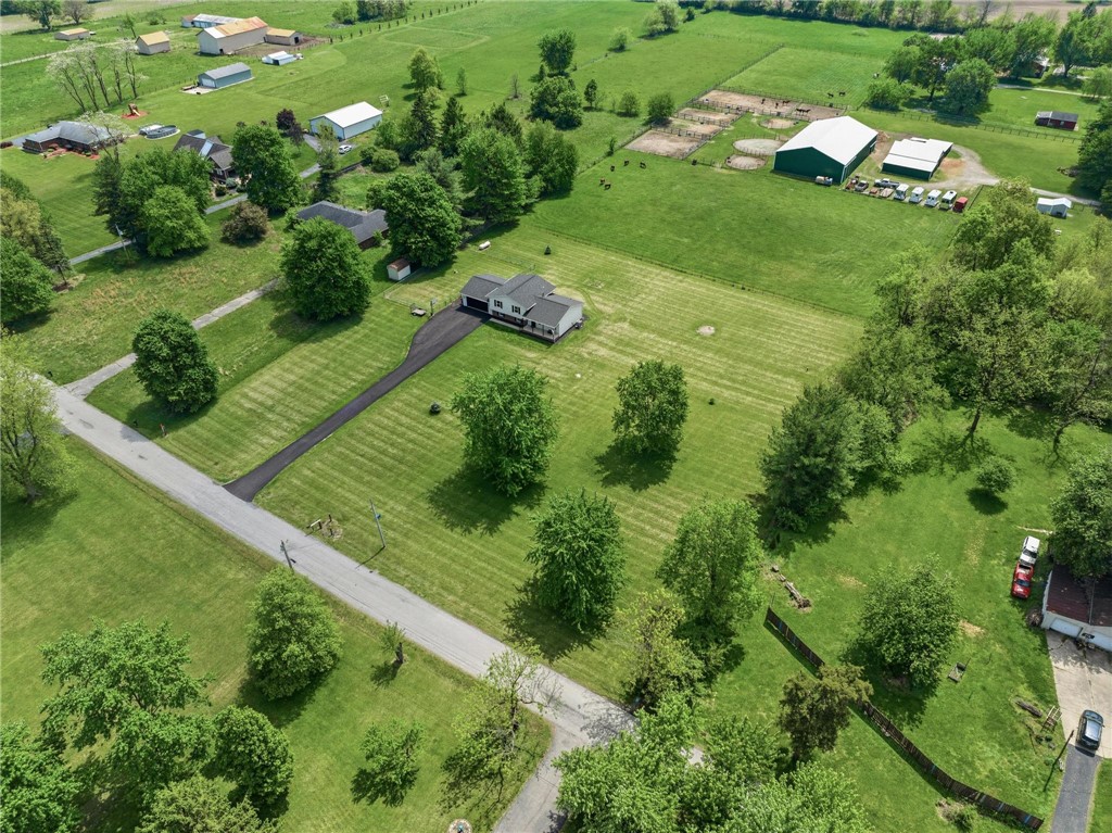 1353 Foust Road Xenia, OH 45385 - Photo 5 of 50 This aerial view showcases a residential property nestled amidst expansive green fields and mature trees.