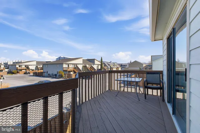 a view of a balcony dining table and chairs