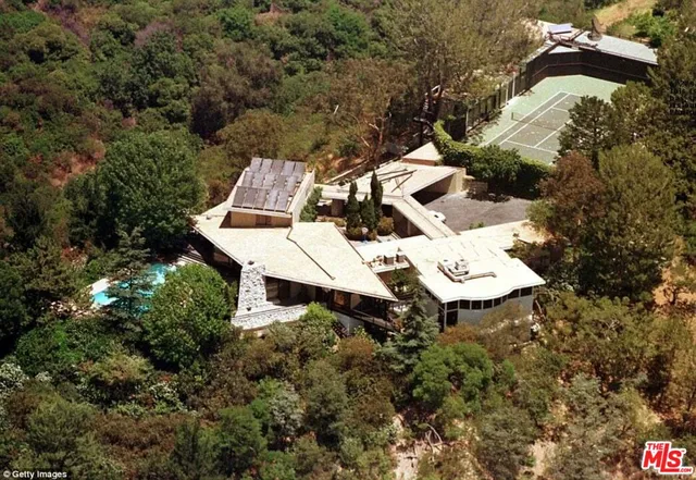 an aerial view of a house with yard and parking