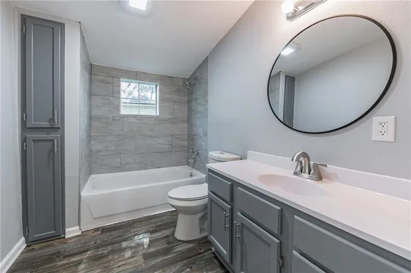 a bathroom with a sink a toilet and a mirror