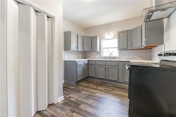 a kitchen with a sink cabinets and window