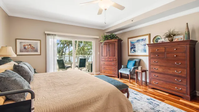 a bedroom with a bed and a dresser next to a window