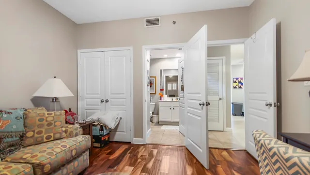 a living room with furniture and a wooden floor