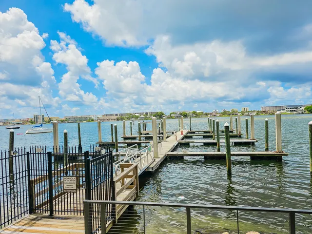 a view of a lake with boats in front of house