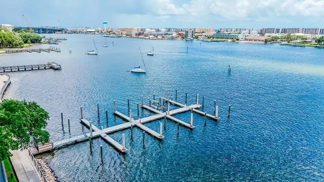 an aerial view of a house with outdoor space and lake view in back