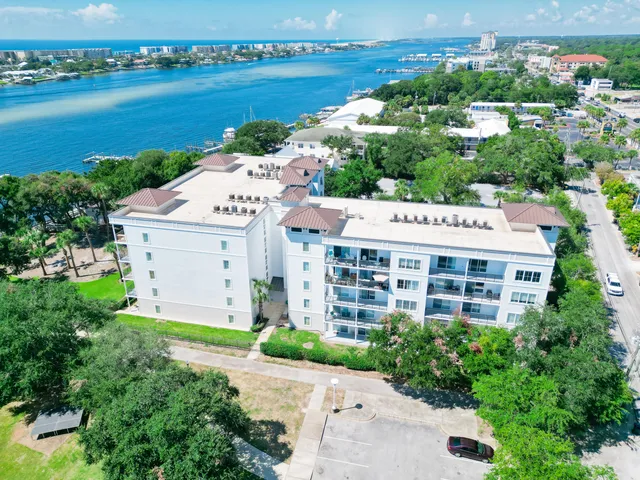 an aerial view of a house with a garden and lake view