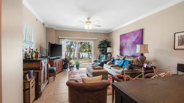 a living room with furniture a flat screen tv and a window