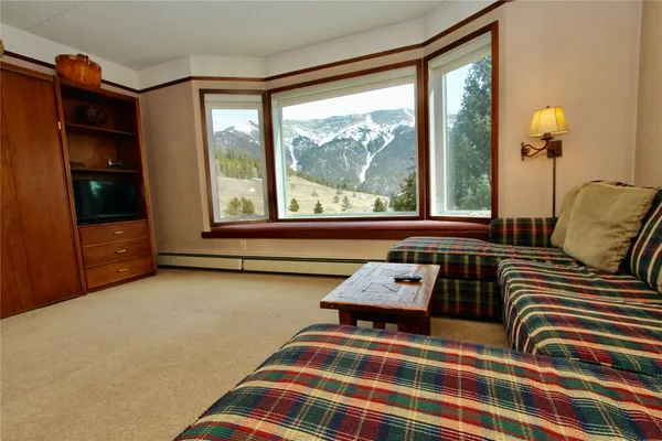 a bedroom with a bed and glass window