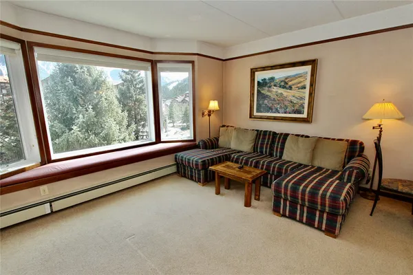 a bedroom with furniture and a large window