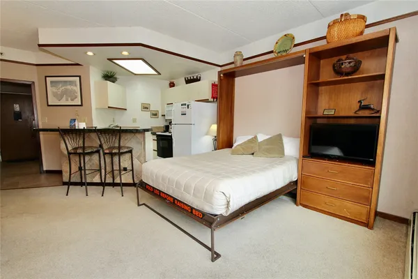 a bedroom with a bed and a dresser