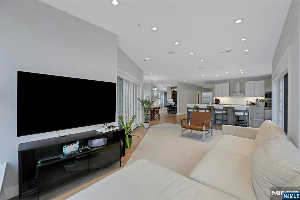 22 Ave At Port Imperial, Unit 114 West New York, NJ 07093 - Photo 12 of 39 a living room with furniture and a flat screen tv