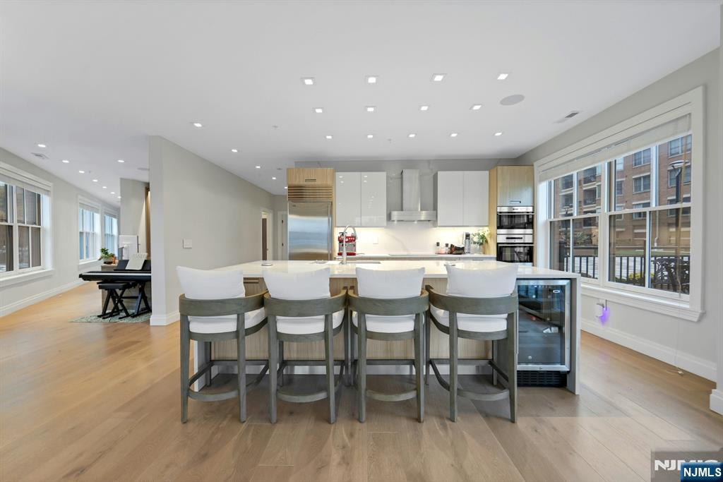 22 Ave At Port Imperial, Unit 114 West New York, NJ 07093 - Photo 13 of 39 a kitchen with a dining table chairs and large window