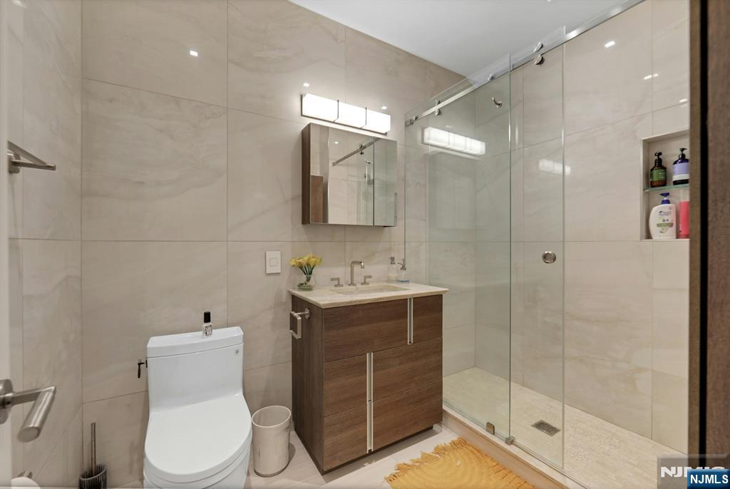 22 Ave At Port Imperial, Unit 114 West New York, NJ 07093 - Photo 16 of 39 a bathroom with a toilet sink and shower