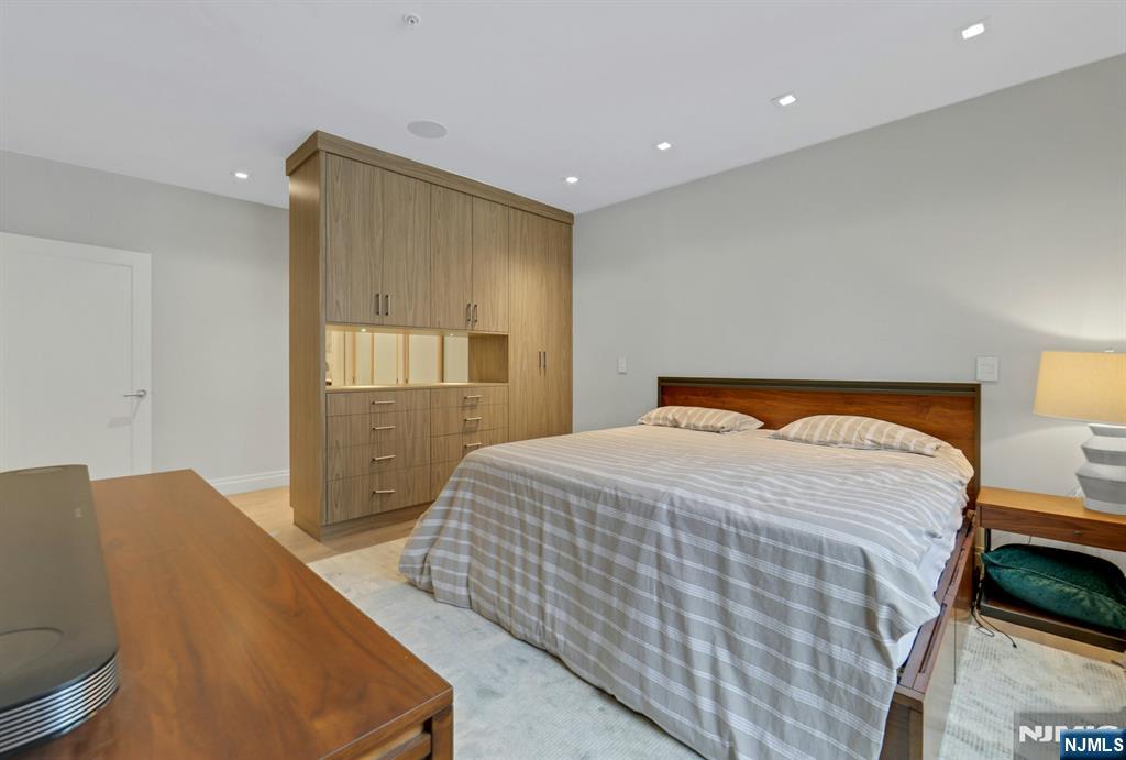 22 Ave At Port Imperial, Unit 114 West New York, NJ 07093 - Photo 20 of 39 a bedroom with a bed and lamp