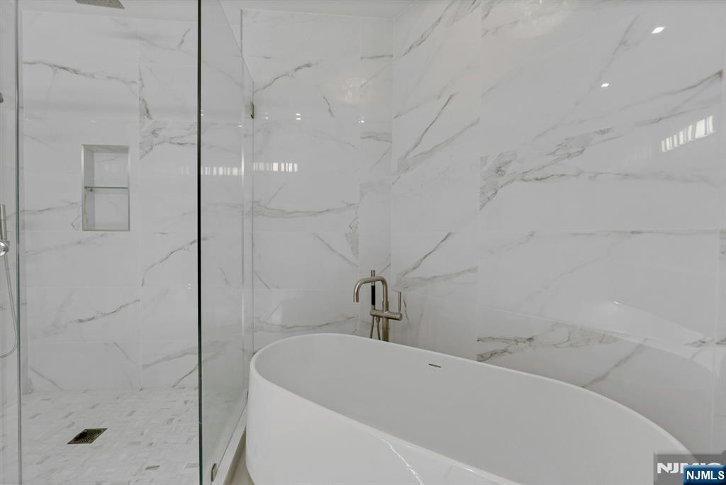 22 Ave At Port Imperial, Unit 114 West New York, NJ 07093 - Photo 24 of 39 a bathroom with a bathtub and shower