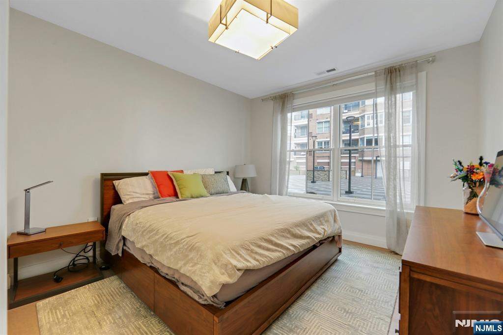 22 Ave At Port Imperial, Unit 114 West New York, NJ 07093 - Photo 25 of 39 a bedroom with a bed and window
