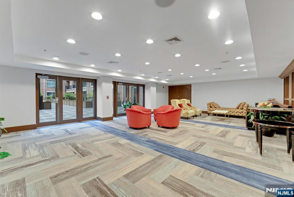 22 Ave At Port Imperial, Unit 114 West New York, NJ 07093 - Photo 35 of 39 a spacious bedroom with a large bed and a table