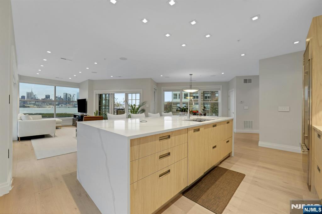 22 Ave At Port Imperial, Unit 114 West New York, NJ 07093 - Photo 4 of 39 a large kitchen with granite countertop a large counter top and stainless steel appliances