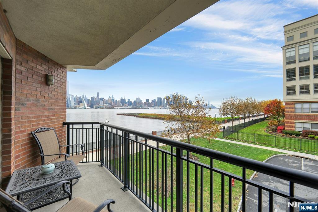 22 Ave At Port Imperial, Unit 114 West New York, NJ 07093 - Photo 9 of 39 a view of a balcony with two chairs and a table