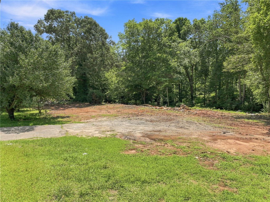 Mature trees frame a cleared lot ready for custom development.