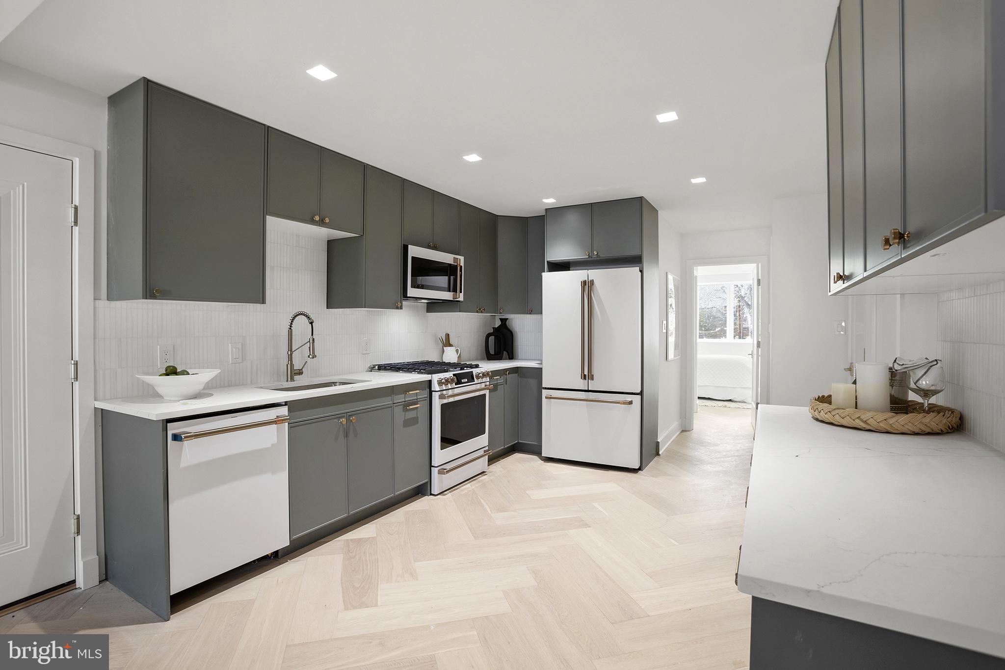 1212 4th Street Northwest, Unit 7 Washington, DC 20001 - Photo 12 of 39 Sleek modern kitchen with herringbone floor.