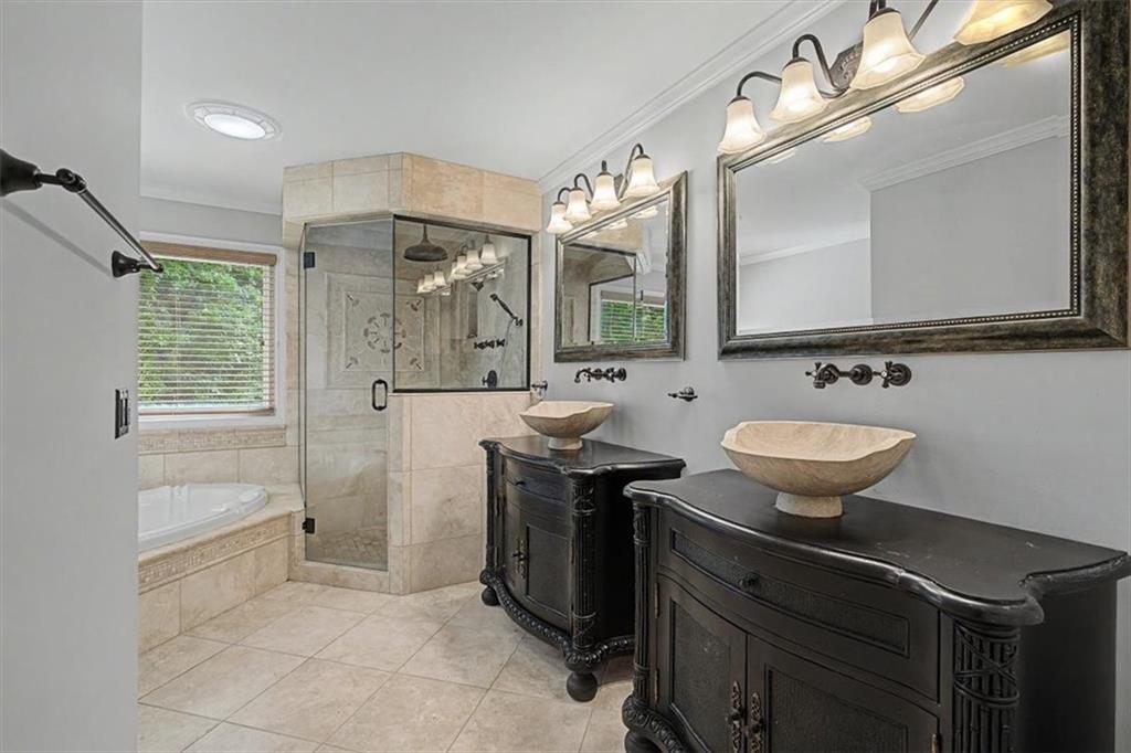4510 North Slope Circle Marietta, GA 30066 - Photo 18 of 37 a bathroom with a sink a mirror a vanity and a shower