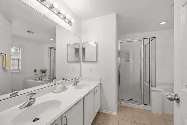 a bathroom with a double vanity sink mirror and double