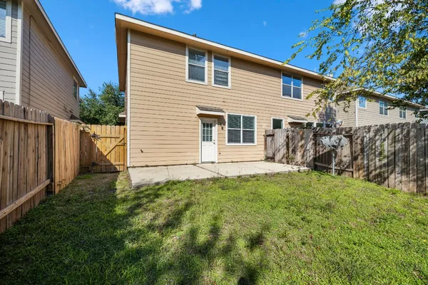 a backyard of a house with table and chairs