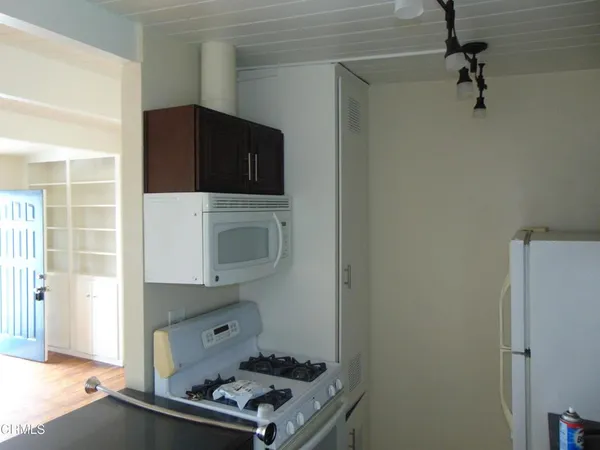 a kitchen with a refrigerator and a stove